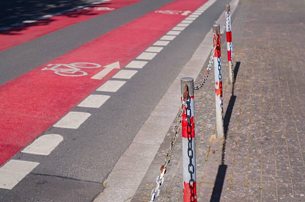 Bike path with dividing posts and chain separating it from pedestrian sidewalk