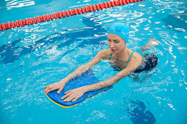 istock Smiling woman in blue cap looking enjoyed while swimming 2215412130