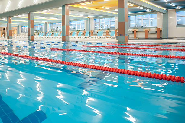 istock Picture of a modern empty swimming pool with blue water 2215412311