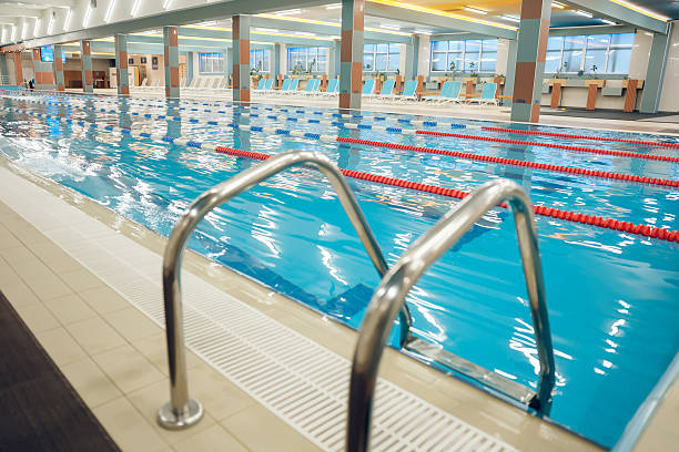 istock Picture of a modern empty swimming pool with blue water 2215412316