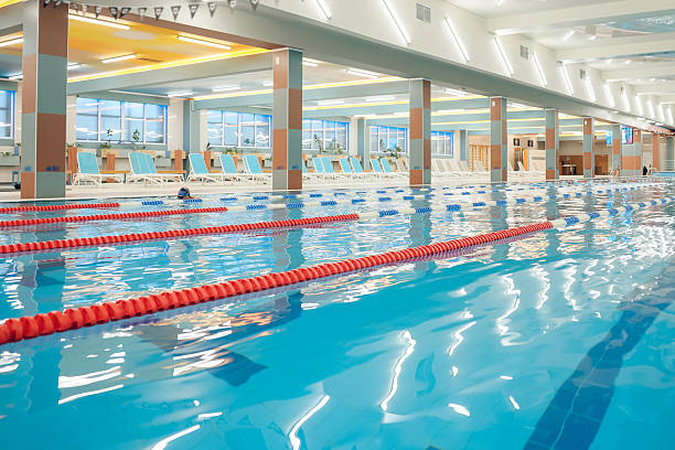 istock Picture of a modern empty swimming pool with blue water 2215412318