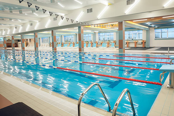 istock Picture of a modern empty swimming pool with blue water 2215412335