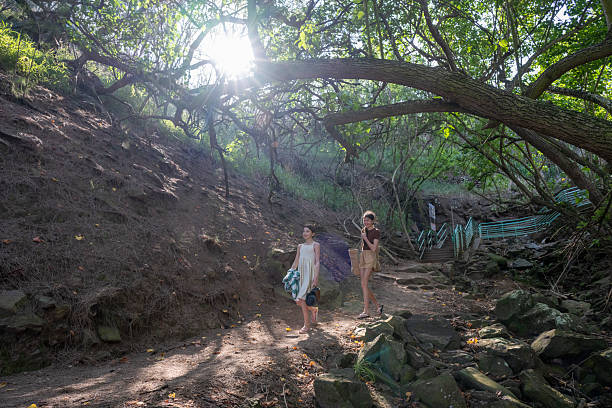 istock Sisters walk along trail in forest, Maui 2215412508