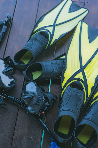 Two sets of snorkelling gear on wooden deck