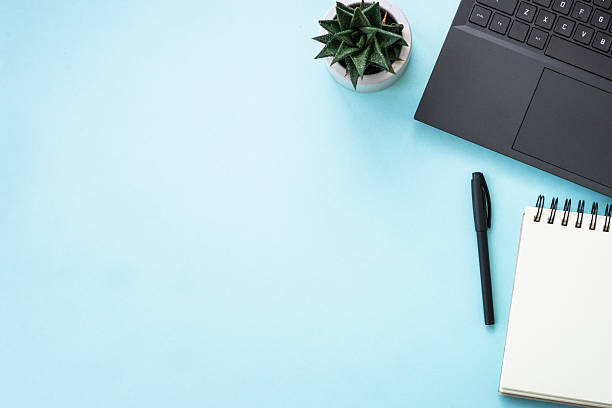 istock Office table desk with laptop, notepad and pen. 2215414718