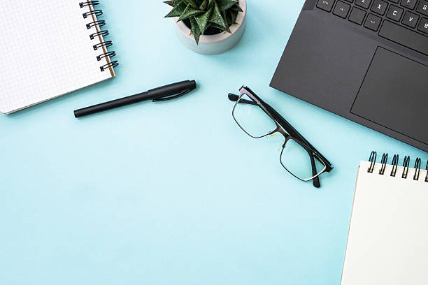istock Office table desk with laptop, notepad and pen. 2215414723