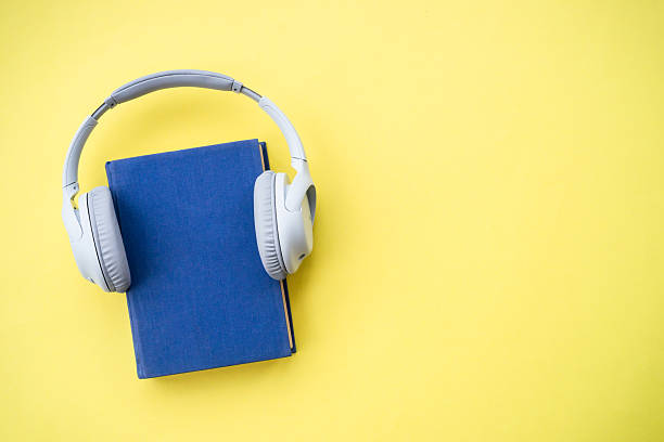 istock Headphones and books on blue background. 2215414965