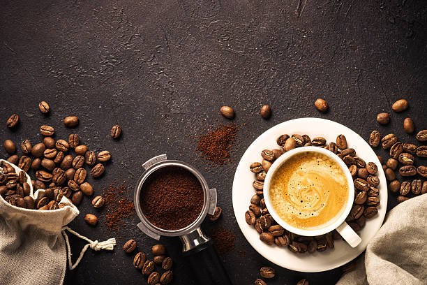 istock Coffee cup and coffee beans at dark table . 2215415263