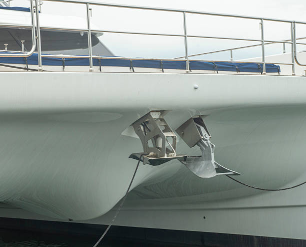 istock Two different anchors, plow type and another spade type mounted on the bow of modern sailing catamaran. 2215415358