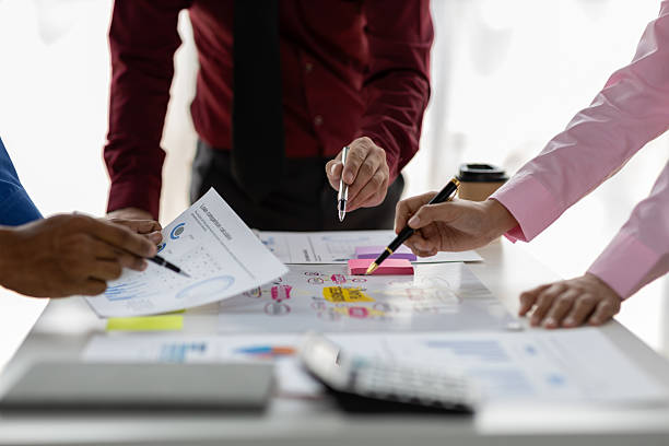 istock Data analysis, marketing strategy or statistics by business development leaders planning company growth. Hands of finance managers in a meeting discussing about financial performance in office. 2215415658