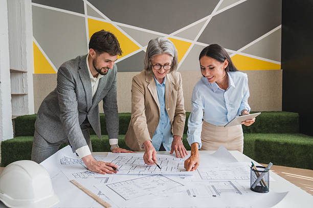 istock Confident engineer team working with Blue Print with architect equipment discussing and planning work flow construction project with partner at the table in office work site. 2215418707