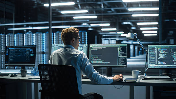 istock In the System Control Room Technical Operator Sits and Monitors Various Activities Showing on Multiple Displays with Graphics. Responsibility for Information Security in the Company Concept 2215423654