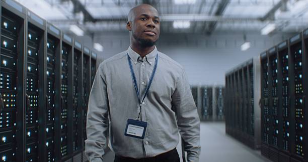 istock Big Data Center with Server Racks and Internet Servers: Specialist Walking In Warehouse 2215423774