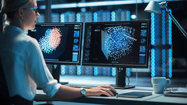 istock Female Technical Operator Works at Her Workstation with Multiple Displays Showing Neural Network In the System Control Room. IT Technician Works on Artificial Intelligence, Big Data Mining Project. 2215423825