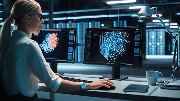 istock European Female Specialist Works on a Computer with Neural Network Visualisation in a Monitoring Center with Global Map Tracking on a Big Digital Screen. Big Data concept 2215425011