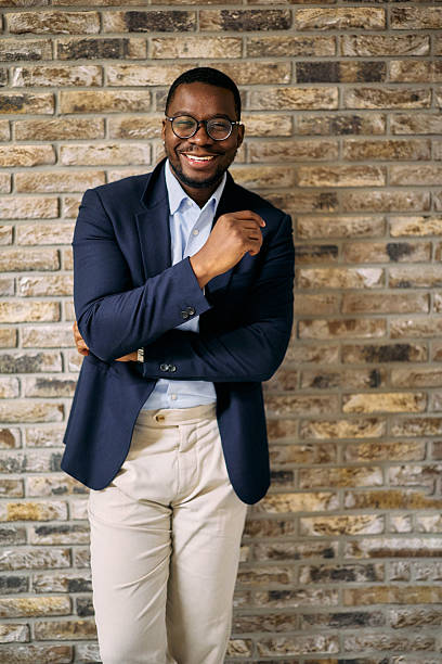 istock Confident businessman smiling with arms crossed in modern office 2215425307