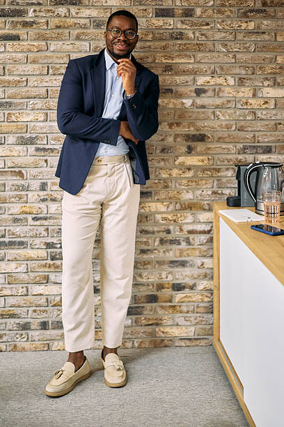Confident businessman posing in modern office break room