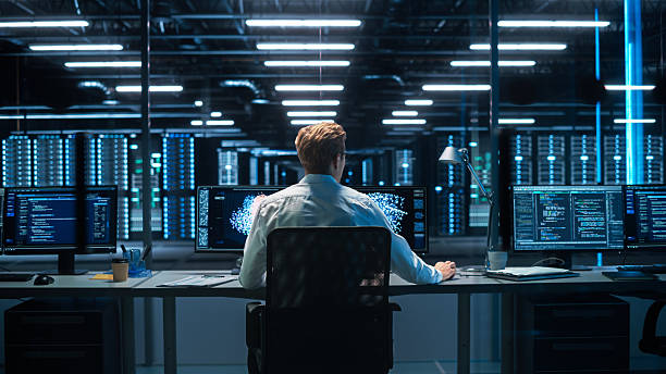 istock Back View of the Male Computer Engineer and Scientist Create Neural Network. In Office Displays Showing 3D Simulation of Big Data, Machine Learning Processes, Web3 Programming Concepts 2215425496