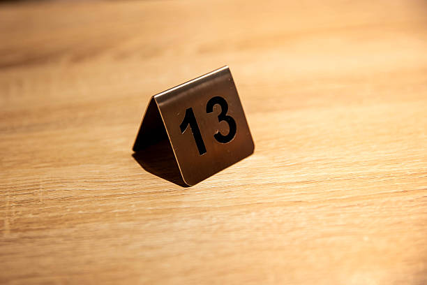 The number 13 on a table, capturing a modern event or restaurant ambiance with elegant decor and a competitive or thematic vibe.