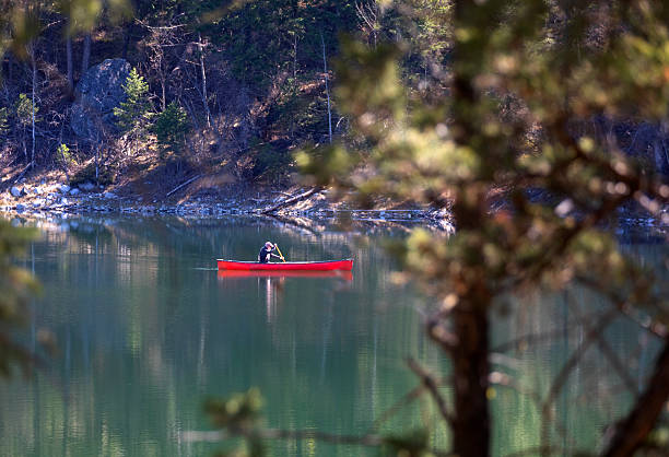 Canada British Columbia. Cranbrook region Lake. Lakit recreation park. Man fishing from a canoe
