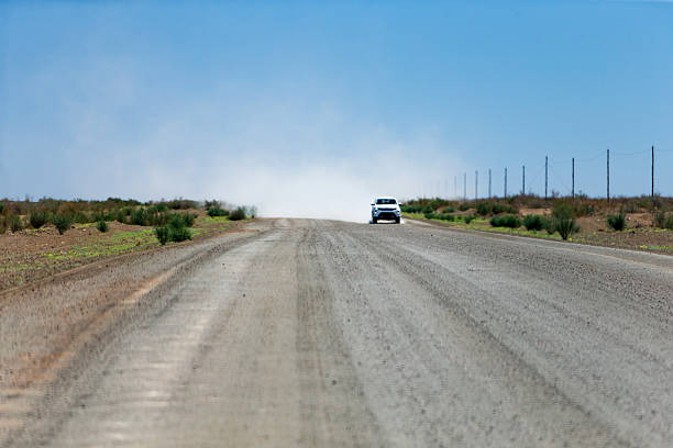 Rural road, truck coming, dust blown up