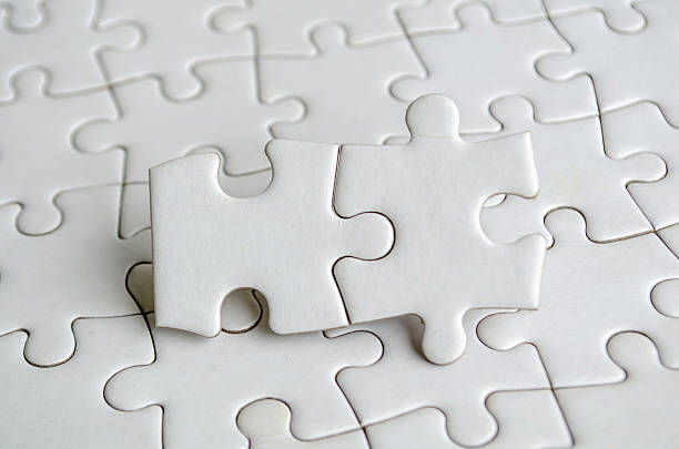 istock Close up of jigsaw puzzle pieces with customizable space on jigsaw for text or ideas 2215429405