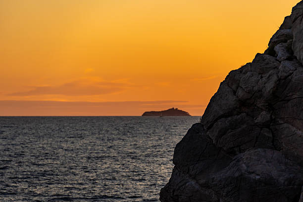 Rocky coastline and sunset over Dubrovnik