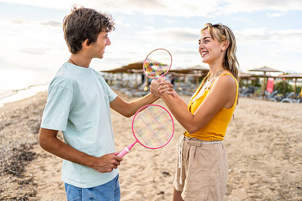 istock Friends shaking hands before playing beach badminton 2215433586