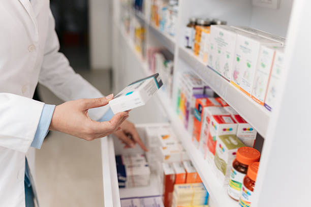 istock Pharmacist picking medicine from pharmacy shelf 2215435693