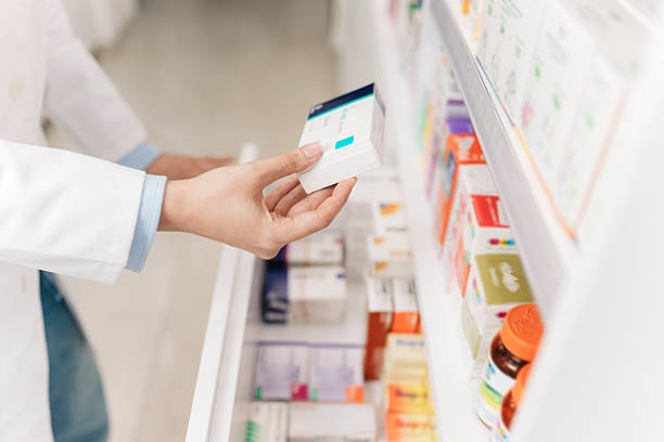 istock Pharmacist picking medicine box from pharmacy refrigerator shelf 2215435699