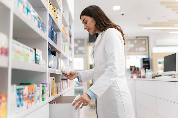 istock Pharmacist picking up medicine from pharmacy shelf 2215435713