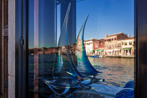 a glass boat on display in a shop in Murano