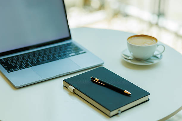 istock Minimalist workspace with coffee, laptop, and notebook  ideal for planning, remote work, and creative focus 2215441063