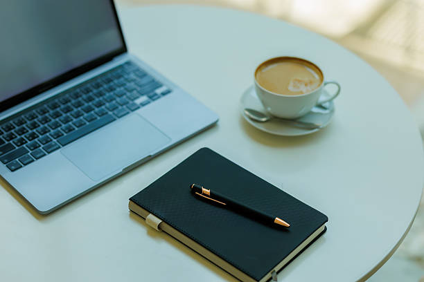 istock Minimalist workspace with coffee, laptop, and notebook  ideal for planning, remote work, and creative focus 2215441084