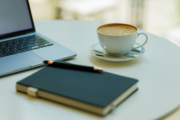 istock Minimalist workspace with coffee, laptop, and notebook  ideal for planning, remote work, and creative focus 2215441564