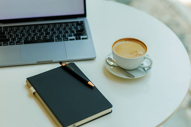 istock Minimalist workspace with coffee, laptop, and notebook  ideal for planning, remote work, and creative focus 2215441595