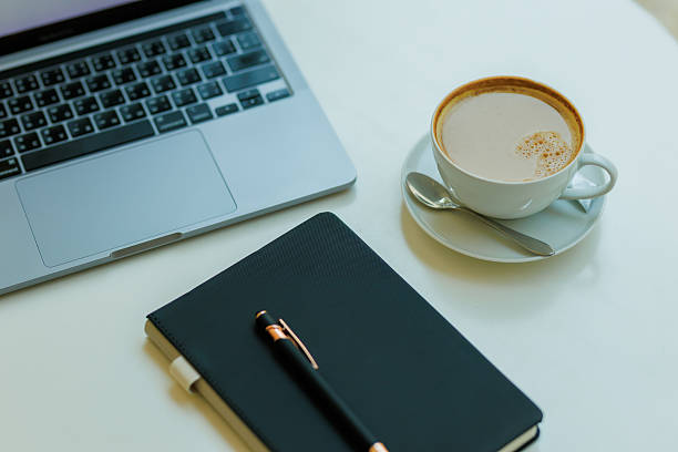 istock Minimalist workspace with coffee, laptop, and notebook  ideal for planning, remote work, and creative focus 2215441612