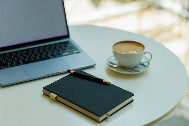 istock Minimalist workspace with coffee, laptop, and notebook  ideal for planning, remote work, and creative focus 2215442603