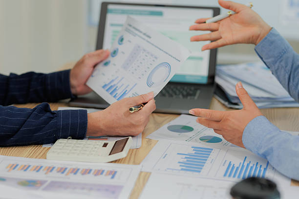 istock Corporate professionals in a strategy meeting analyzing charts and financial data, showcasing themes of business consulting, teamwork, and leadership development. 2215443841