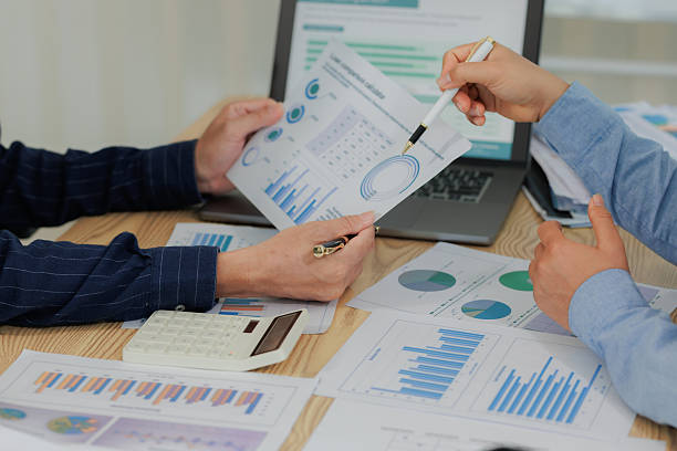 istock Corporate professionals in a strategy meeting analyzing charts and financial data, showcasing themes of business consulting, teamwork, and leadership development. 2215443843