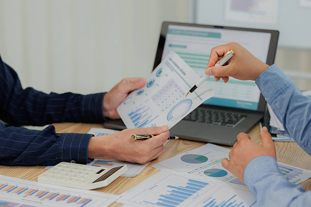 istock Corporate professionals in a strategy meeting analyzing charts and financial data, showcasing themes of business consulting, teamwork, and leadership development. 2215443846