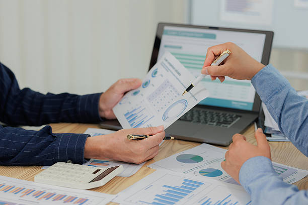istock Corporate professionals in a strategy meeting analyzing charts and financial data, showcasing themes of business consulting, teamwork, and leadership development. 2215443849
