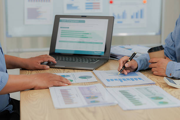 istock Corporate professionals in a strategy meeting analyzing charts and financial data, showcasing themes of business consulting, teamwork, and leadership development. 2215443876