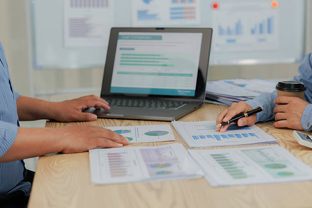 istock Corporate professionals in a strategy meeting analyzing charts and financial data, showcasing themes of business consulting, teamwork, and leadership development. 2215443877