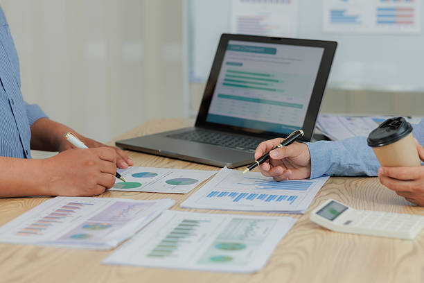 istock Corporate professionals in a strategy meeting analyzing charts and financial data, showcasing themes of business consulting, teamwork, and leadership development. 2215443896