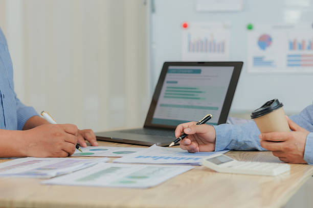 istock Corporate professionals in a strategy meeting analyzing charts and financial data, showcasing themes of business consulting, teamwork, and leadership development. 2215443904