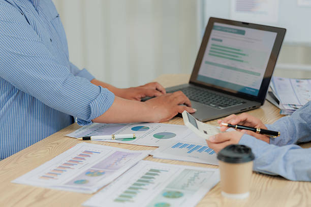 istock Corporate professionals in a strategy meeting analyzing charts and financial data, showcasing themes of business consulting, teamwork, and leadership development. 2215443914