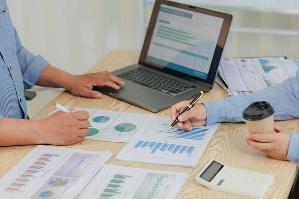 istock Corporate professionals in a strategy meeting analyzing charts and financial data, showcasing themes of business consulting, teamwork, and leadership development. 2215443915