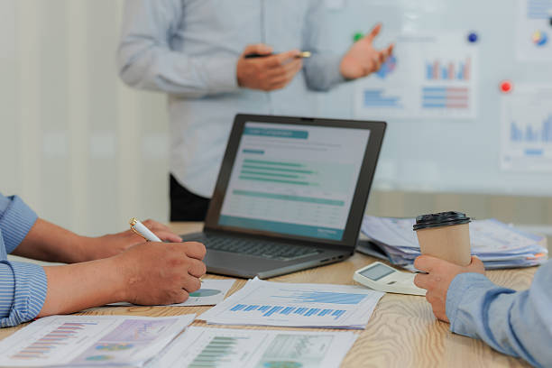 istock Team reviewing financial data and marketing plans using digital devices, highlighting collaboration, strategy, and business performance. 2215443967