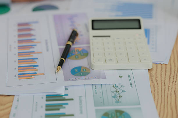 Corporate professionals in a strategy meeting analyzing charts and financial data, showcasing themes of business consulting, teamwork, and leadership development.
